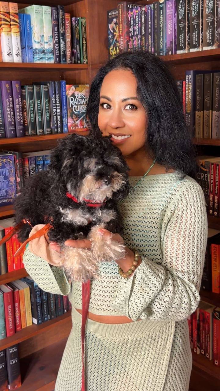 Yenis Monterrey founder of ATX Small Dogs holding her Maltipoo